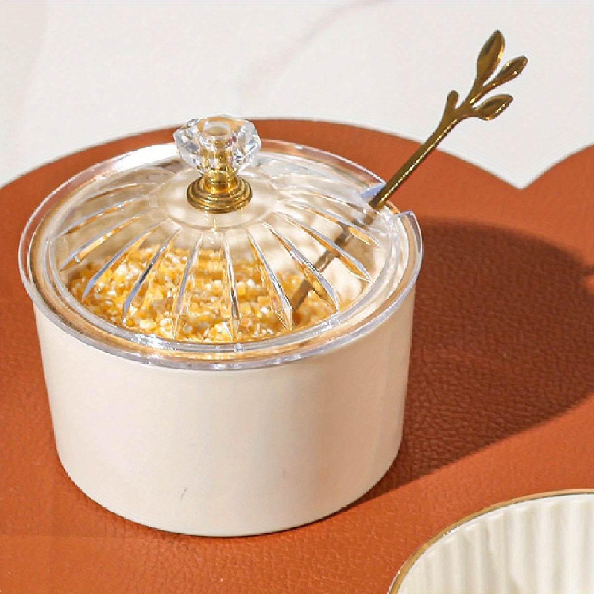 Handmade Nordic luxury PS condiment jar with spoon and lid for kitchen seasoning storage.