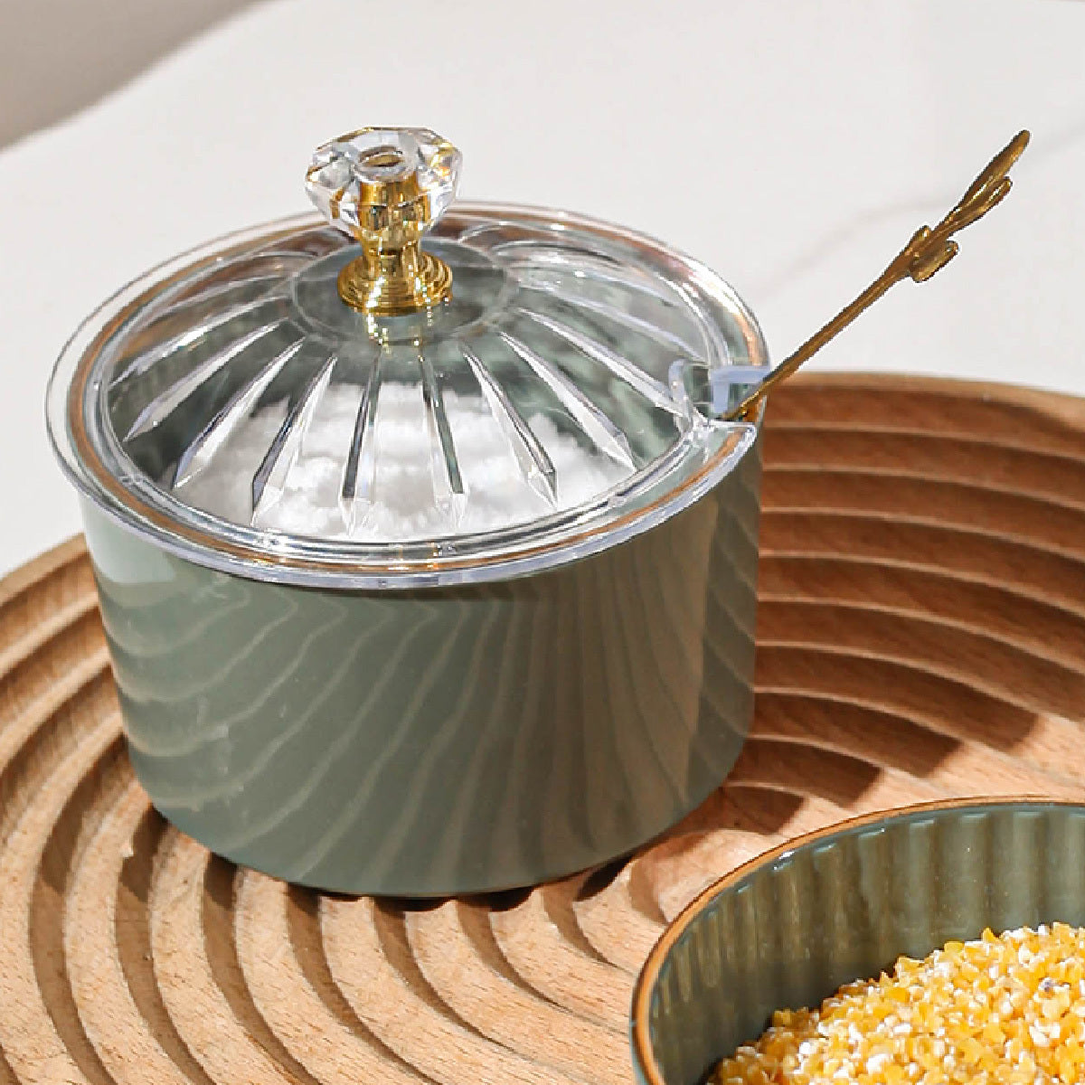 Handmade Nordic luxury PS condiment jar with spoon and lid for kitchen seasoning storage.