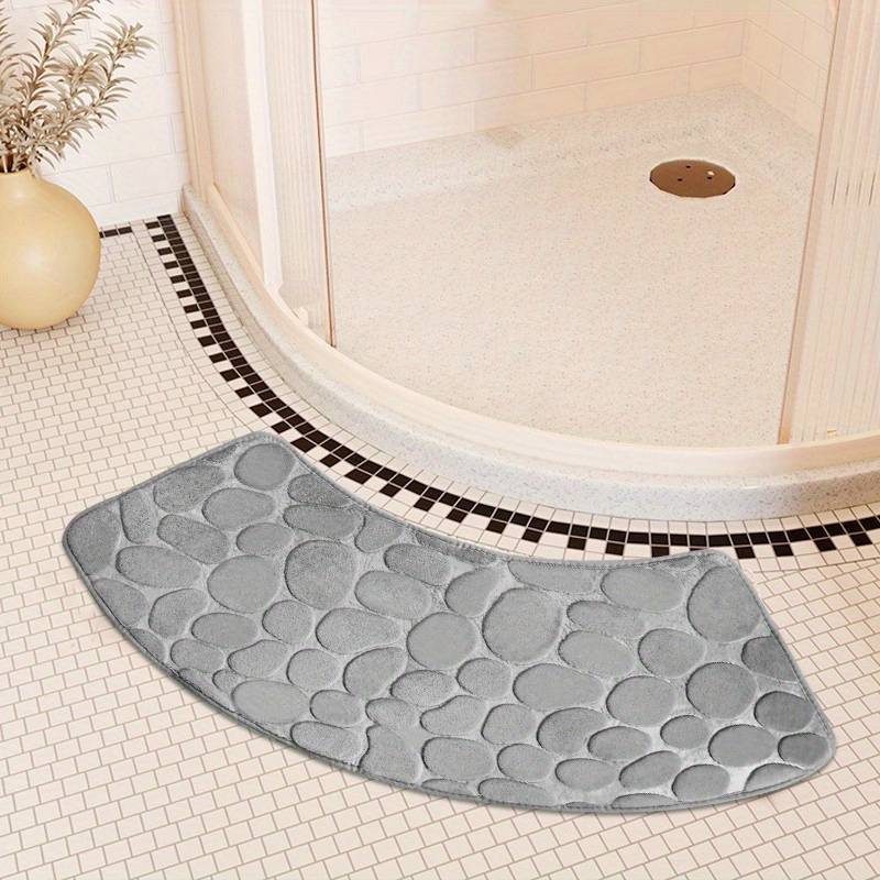 This bath mat features a stylish pebble pattern and a curved corner design, making it both functional and decorative. Made from soft, non-slip, and quick-drying material, this absorbent shower carpet is the perfect accessory for your home bathroom.