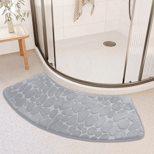 This bath mat features a stylish pebble pattern and a curved corner design, making it both functional and decorative. Made from soft, non-slip, and quick-drying material, this absorbent shower carpet is the perfect accessory for your home bathroom.