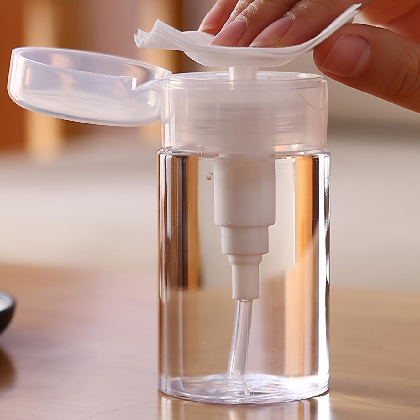 Travel-friendly transparent cosmetic storage box with liquid dispenser for home organization.