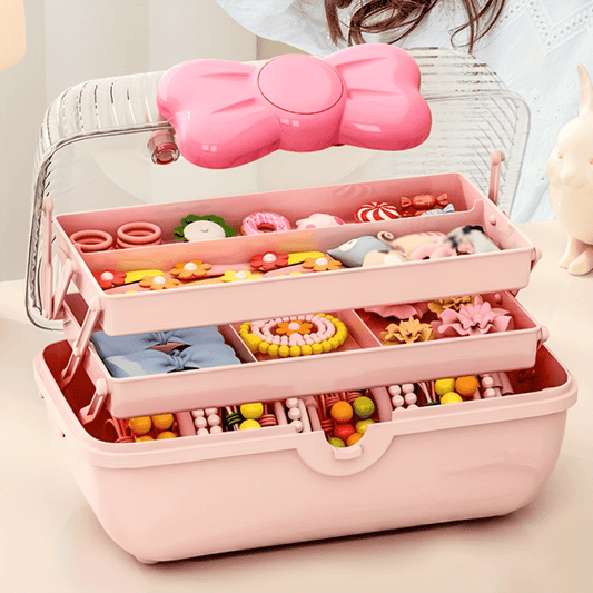 Pink multi-layer storage box with bow, perfect for jewelry, cosmetics, toys. Durable plastic organizer with transparent lid for dolls, hair accessories, trinkets.