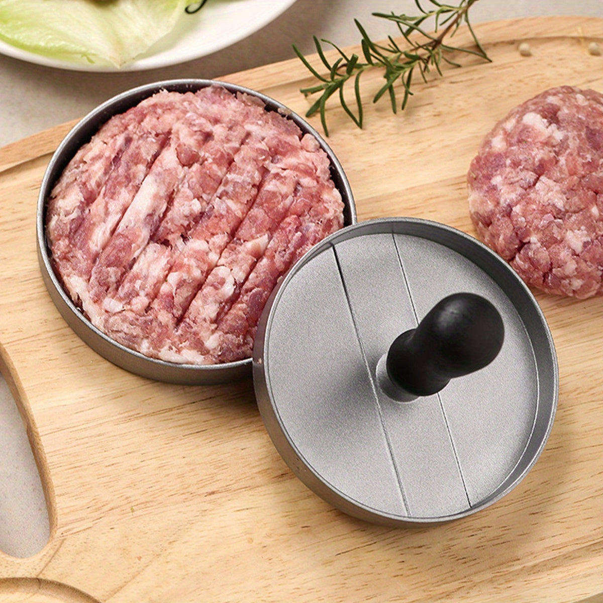 Create perfect hamburger patties with the Aluminum Burger Press Patty Maker, featuring a non-stick coating and includes wax paper discs. This kitchen gadget is food contact safe cookware, making it easy and convenient to use.