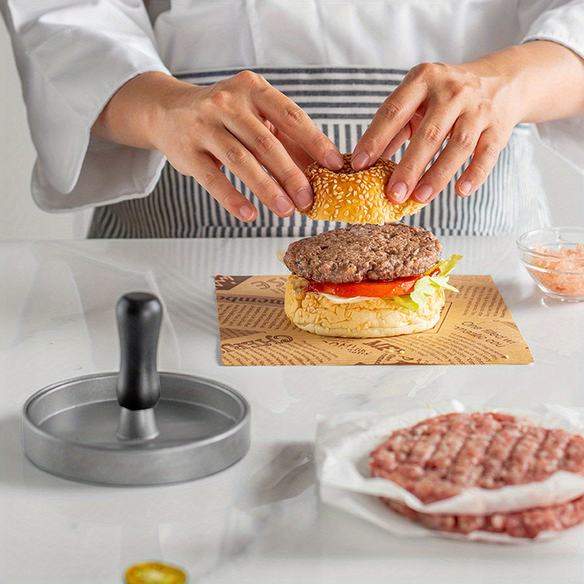 Create perfect hamburger patties with the Aluminum Burger Press Patty Maker, featuring a non-stick coating and includes wax paper discs. This kitchen gadget is food contact safe cookware, making it easy and convenient to use.