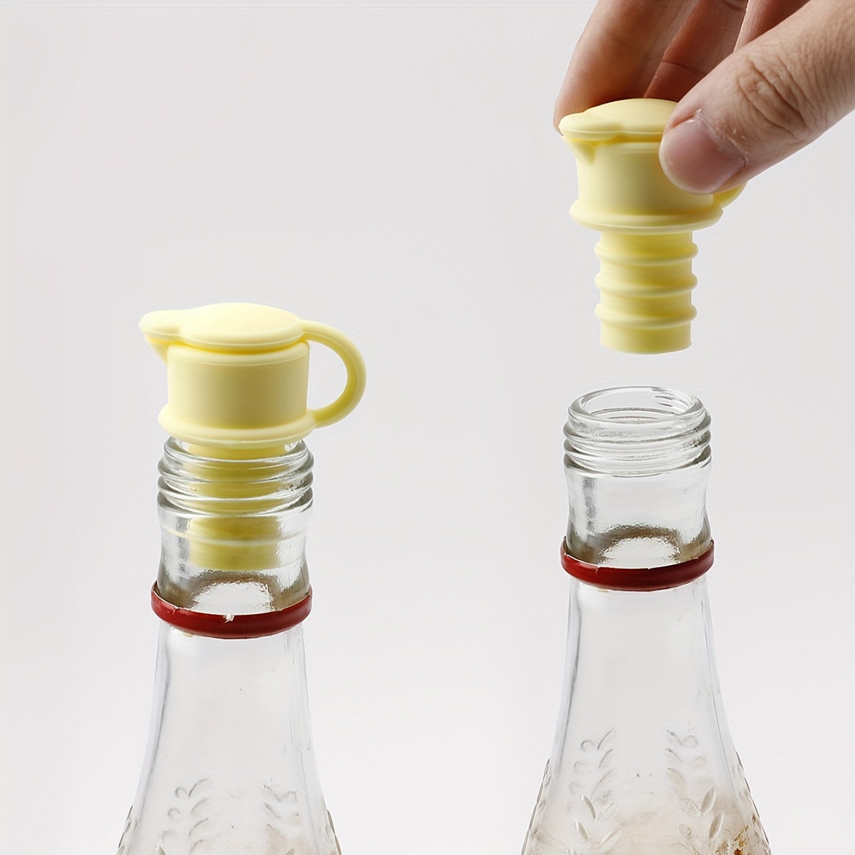 3 yellow silicone wine stoppers for preserving and seasoning wine and champagne in standard bottles. Leakproof and reusable.