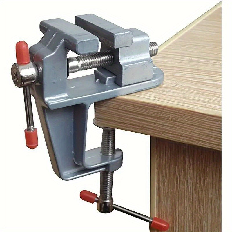 Mini aluminum bench vise with adjustable table clamp for DIY projects.