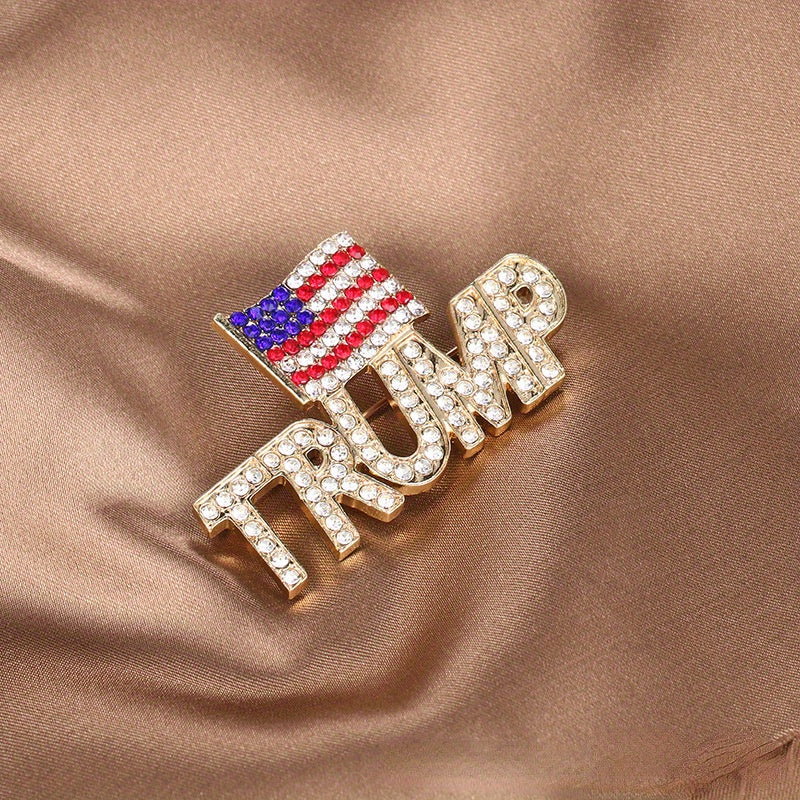 Add a touch of elegance with the Luxury Rhinestone Trump Brooch Pin featuring an American Flag design. This Novelty Irregular Shape Fashion Accessory is perfect for both men and women, showcasing an Elegant Crystal Patriotic Emblem. Available in a set of