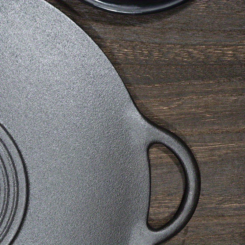 Single non-stick skillet made of cast iron with two handles for grilling and frying. Can be used on gas and induction stoves. Handwashing recommended.