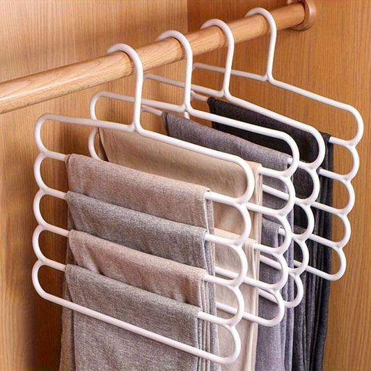 Three pieces of a multifunctional five-layer pants rack with anti-slip features. This rack can store multi-layer clothing in wardrobes and serves as a clothes hanger with scarf storage capability. Ideal for organizing pants.