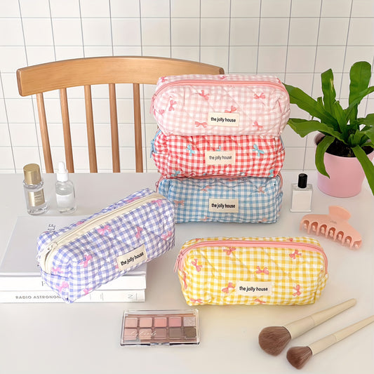 Polyester plaid pencil case with bowknot design for women and girls.