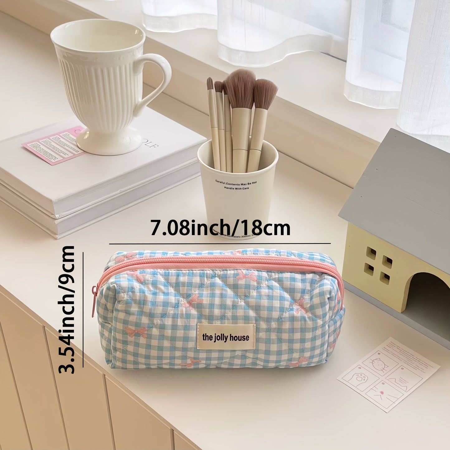 Polyester plaid pencil case with bowknot design for women and girls.