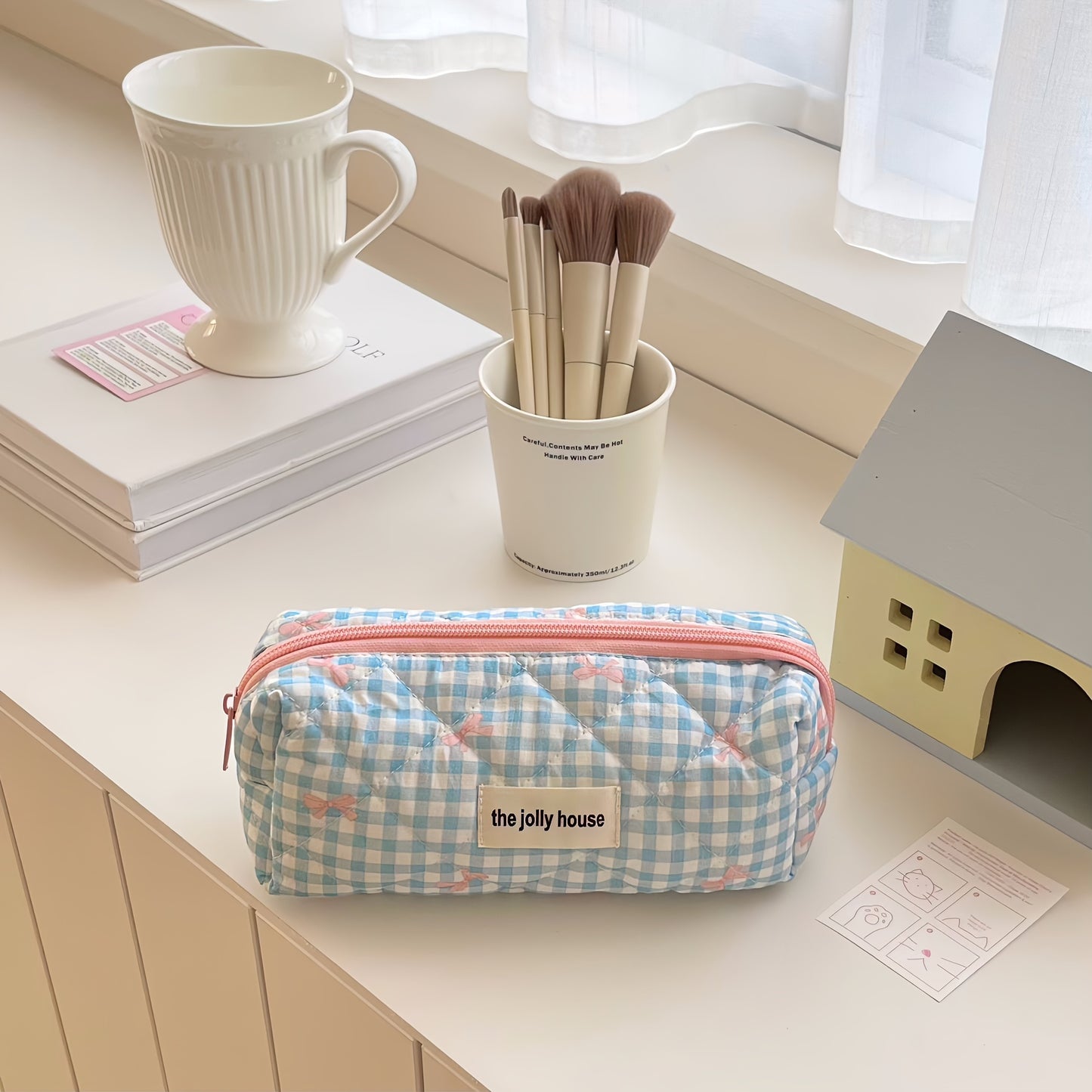 Polyester plaid pencil case with bowknot design for women and girls.