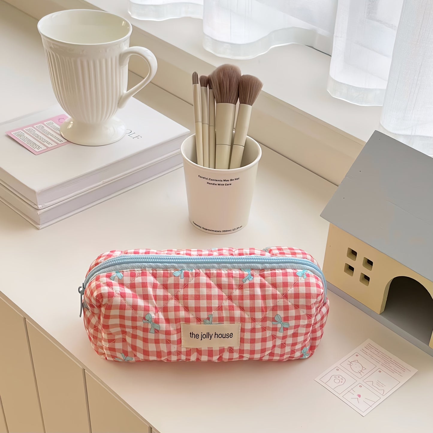 Polyester plaid pencil case with bowknot design for women and girls.