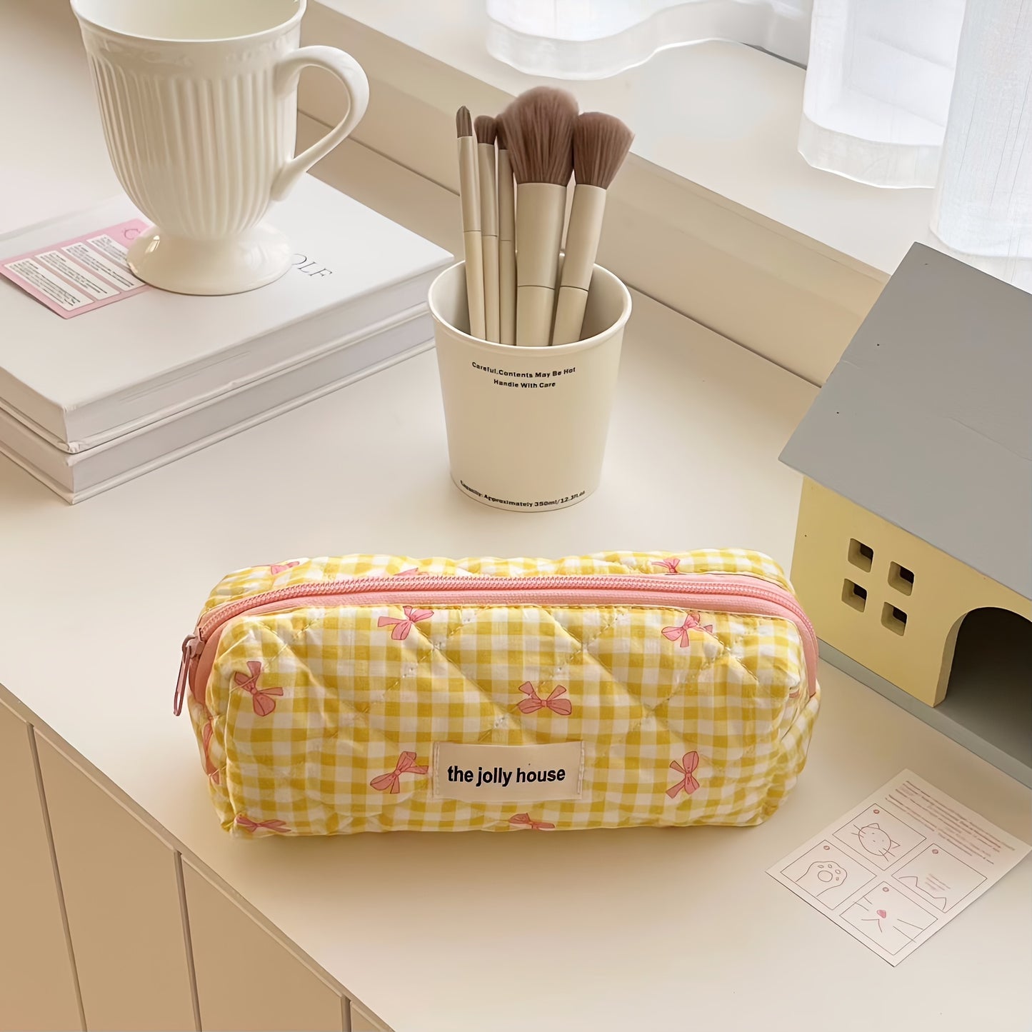 Polyester plaid pencil case with bowknot design for women and girls.