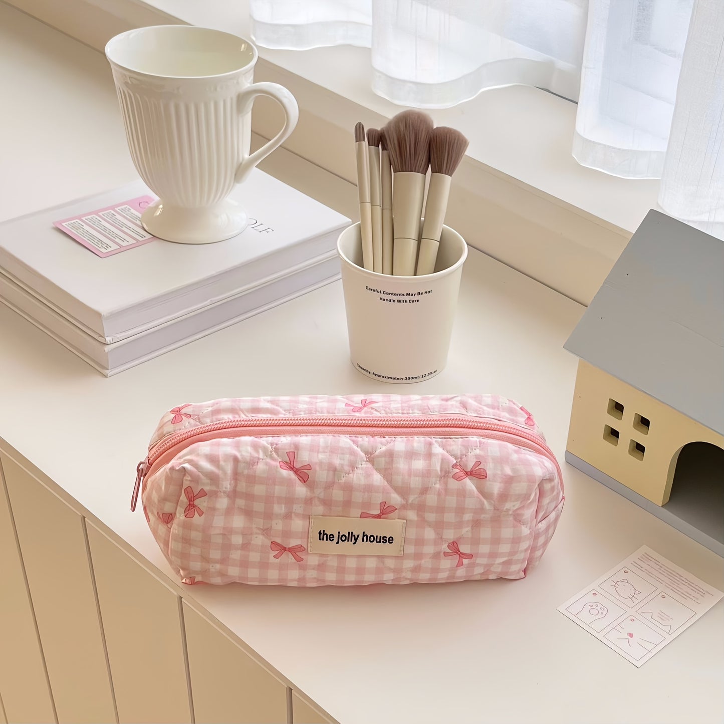 Polyester plaid pencil case with bowknot design for women and girls.