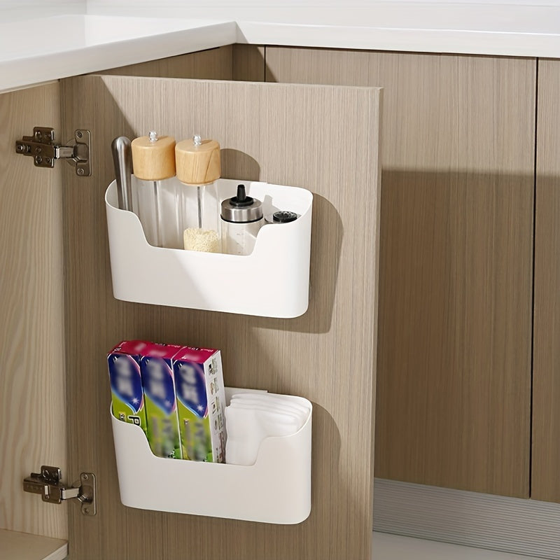 Wall-mounted storage holder with adhesive backing for under-sink organization, suitable for kitchen or bathroom use. Plastic shelf that requires no drilling for installation.