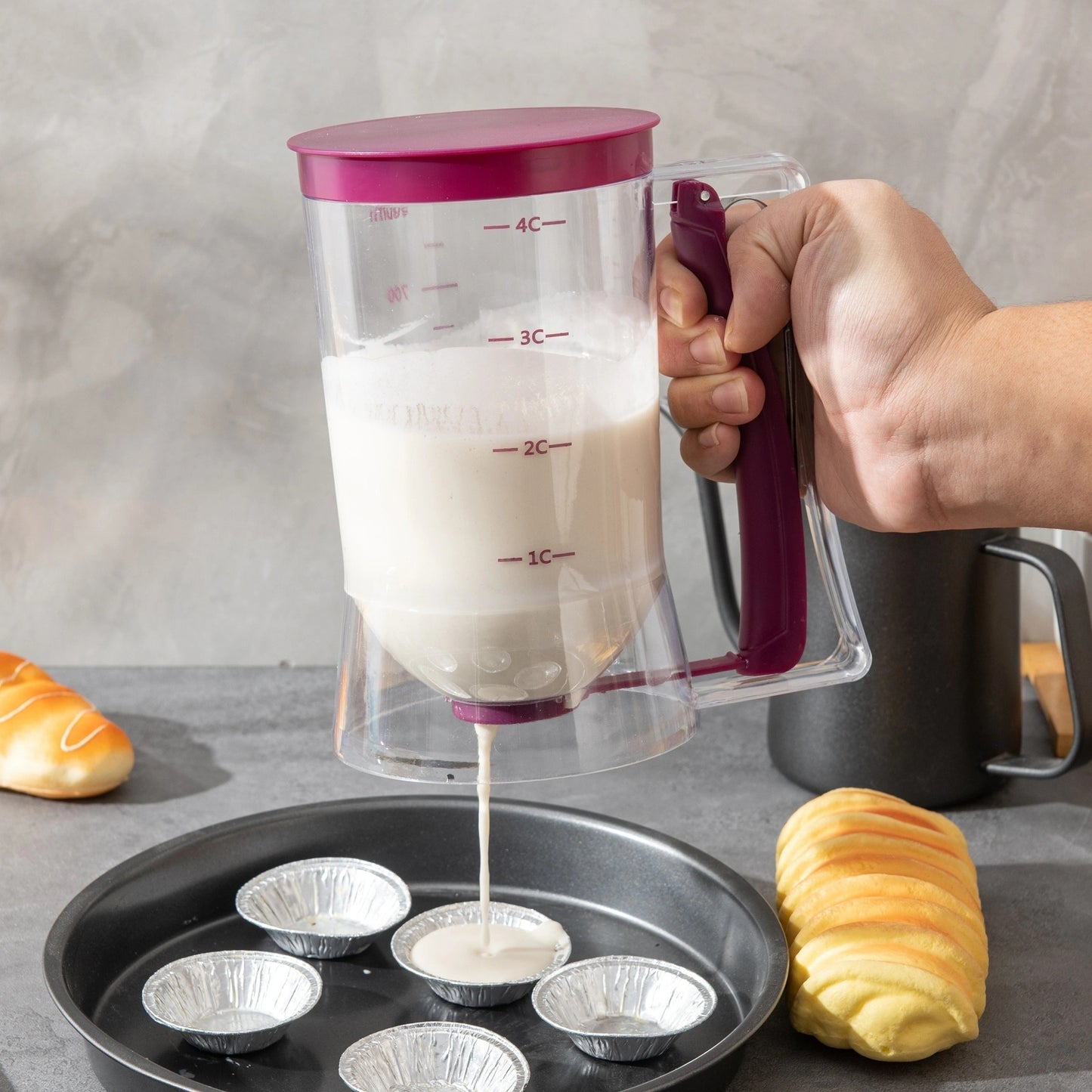 Durable cupcake batter dispenser with measurement markings, non-stick design for perfect baking, easy-to-clean plastic, food-safe.