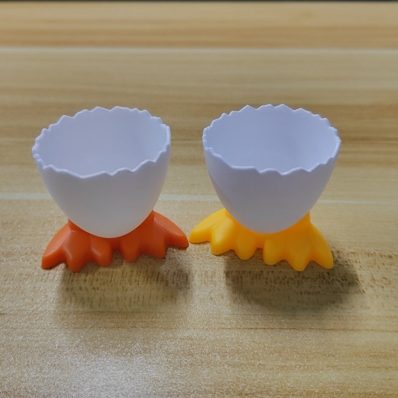 4 plastic egg cup holders with cartoon base design, perfect for boiled eggs. Durable, kid-friendly, and ideal for breakfast and parties.