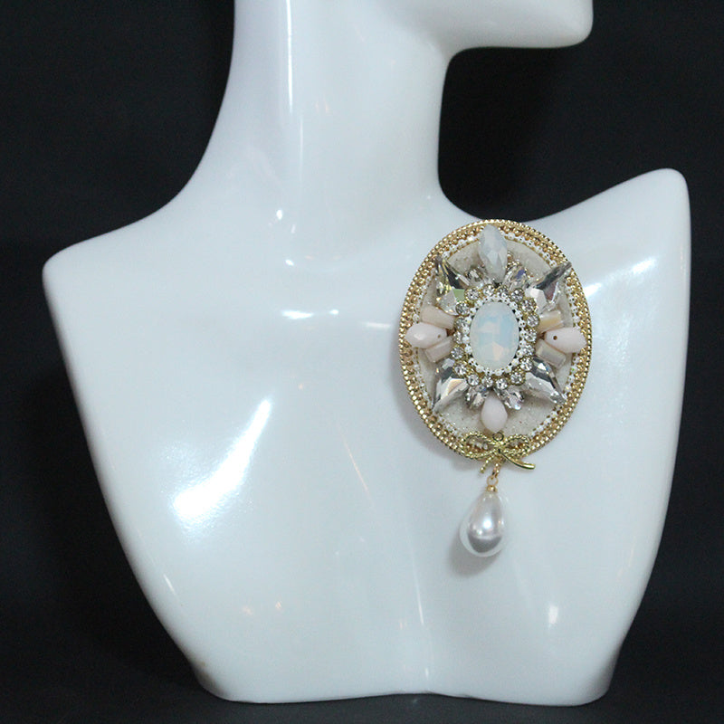 Stylish and Opulent Unique Brooch Adorned with Faux Pearl Pendant, Oval Design, Fashionable and Trendy Accent.