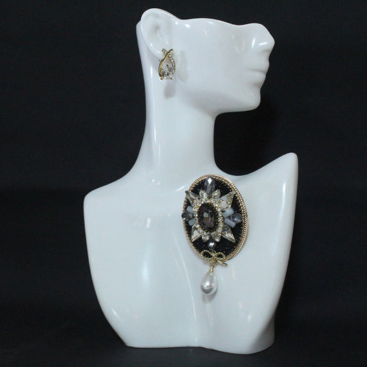 Stylish and Opulent Unique Brooch Adorned with Faux Pearl Pendant, Oval Design, Fashionable and Trendy Accent.