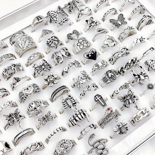 Lot of 30/50 pieces of hip hop vintage rings for women and men, made of alloy. These wholesale punk rings feature heart, flower, skull, butterfly, and Tai Chi designs. Perfect for parties or as a gift, each ring comes in an opp bag.