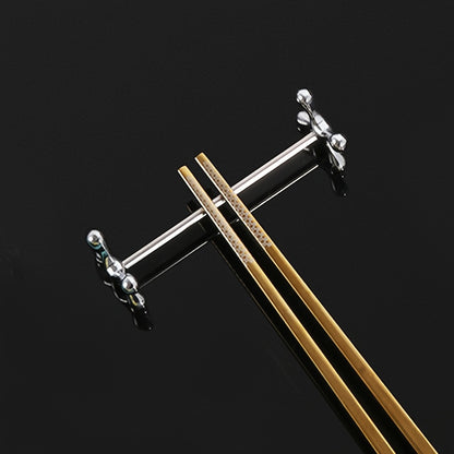 Metal chopstick rests that can also hold forks, spoons, and pens. Japanese-Korean style dining accessory in a set of 1.