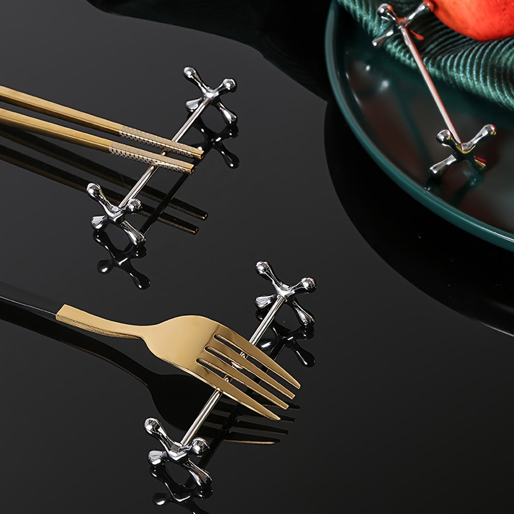 Metal chopstick rests that can also hold forks, spoons, and pens. Japanese-Korean style dining accessory in a set of 1.