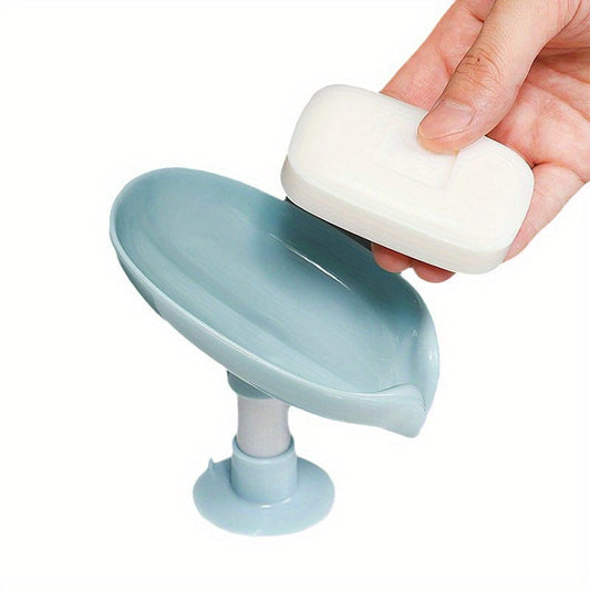 Wall-mounted soap dish with suction cup for bathroom storage, no drilling required. Oval plastic holder with drainage.