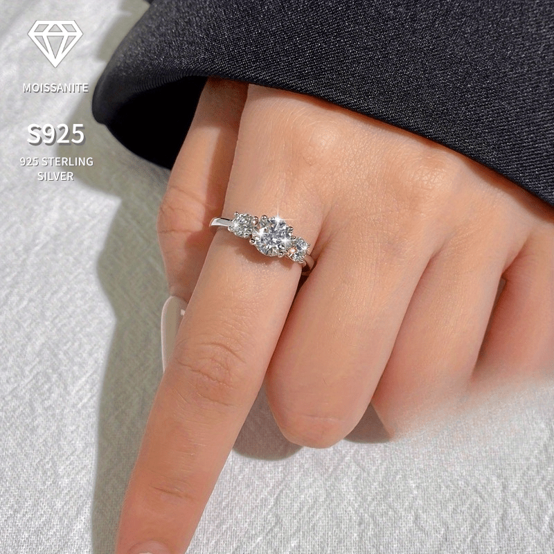 This classic and elegant three-stone ring is a fashionable choice. Crafted from 925 silver, it features three moissanite stones inlaid in a timeless design. This versatile piece is perfect for daily wear or as a thoughtful gift for someone special.