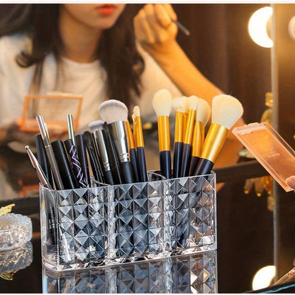 Stylish acrylic makeup brush holder with diamond pattern design and three compartments for pens, eyebrow pencils, and lipstick. Perfect for home organization.