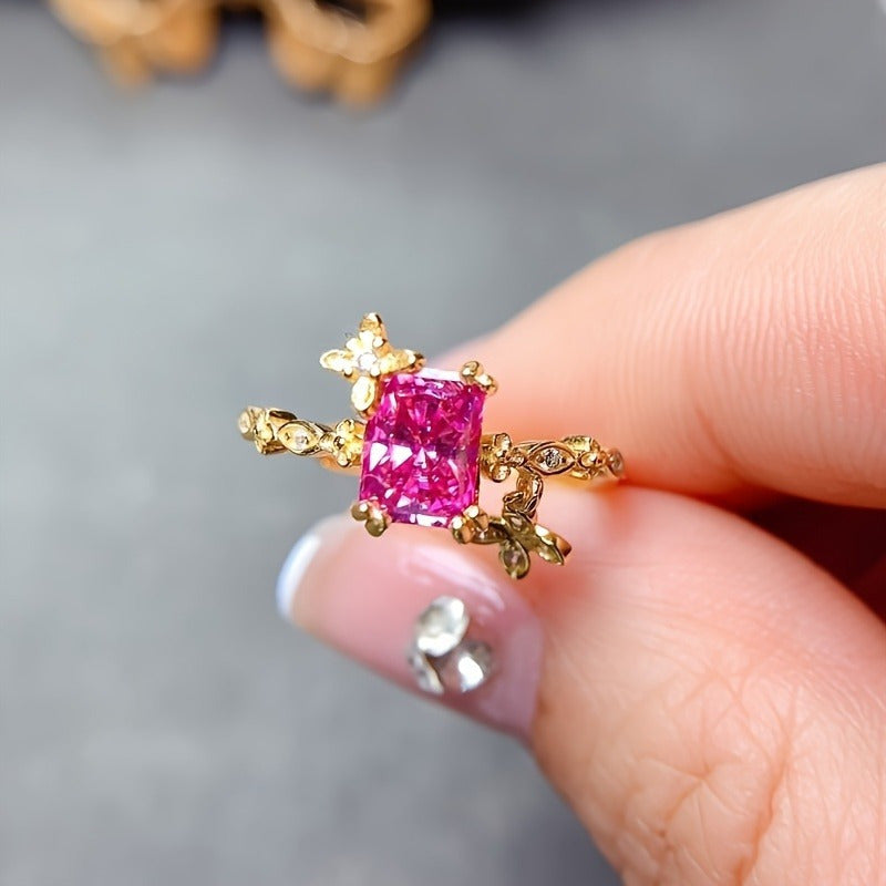 This elegant luxury pink Moissanite ring features a 1ct stone set in 925 sterling silver with 18K golden plating. The ring showcases a beautiful floral design and is hypoallergenic, making it suitable for daily wear, parties, Valentine's Day, and