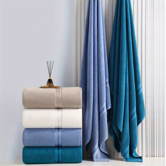 Luxurious oversized bath towel made of 100% cotton with high absorbency and soft, thick texture in beige and blue striped design, ideal for home, spa, and outdoor use.