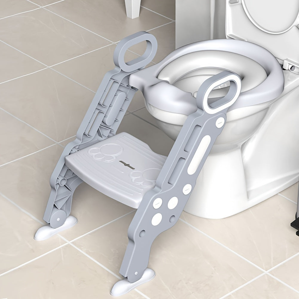 A folding staircase-type children's toilet seat with an auxiliary stool cushion for a baby girl or baby boy in the household restroom.