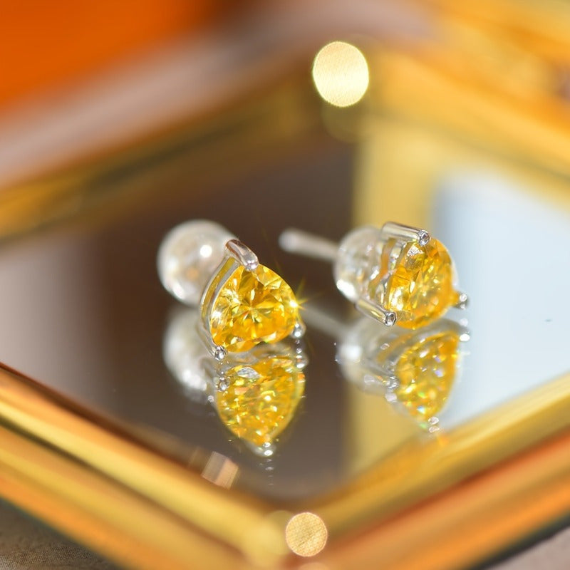 Celebrate Valentine's Day with these stunning 1ct heart-shaped yellow Moissanite stud earrings! Made of 925 sterling silver with vintage sexy styling, these earrings are perfect for all seasons, daily wear, and music festivals. The silver Moissanite