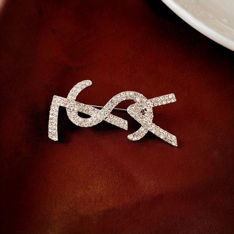 Elevate your look with this chic and sophisticated French-inspired alphabet brooch featuring stunning diamonds, perfect for women who want to add a touch of elegance and luxury to their outfits. Ideal for enhancing the sophisticated and high-end appeal