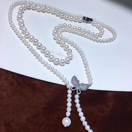 This Elegant Double Strand Freshwater Pearl Necklace features a Vintage Style Butterfly Pendant - Perfect Fashion Accessory for daily wear, Autumn season, or Mardi Gras Day Celebration.