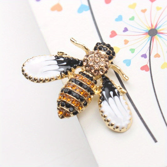 Charming and whimsical, this elegant and cute bee brooch pin features sparkling rhinestones. A delightful insect lapel accessory for women, it makes the perfect gift idea.