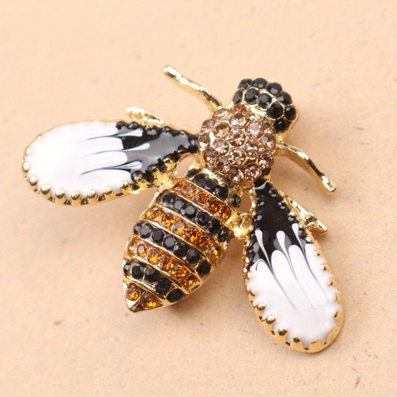 Charming and whimsical, this elegant and cute bee brooch pin features sparkling rhinestones. A delightful insect lapel accessory for women, it makes the perfect gift idea.