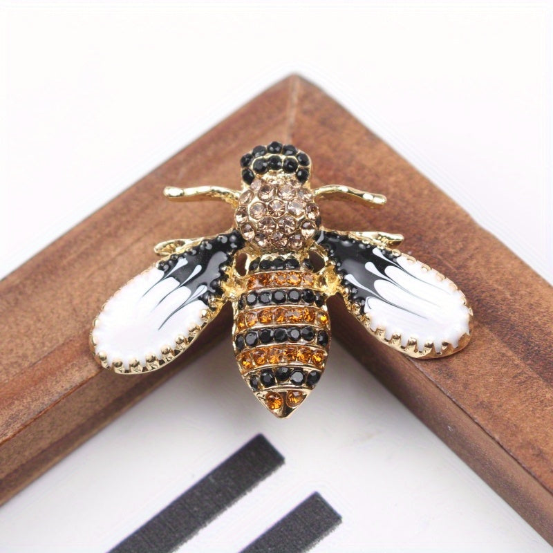 Charming and whimsical, this elegant and cute bee brooch pin features sparkling rhinestones. A delightful insect lapel accessory for women, it makes the perfect gift idea.