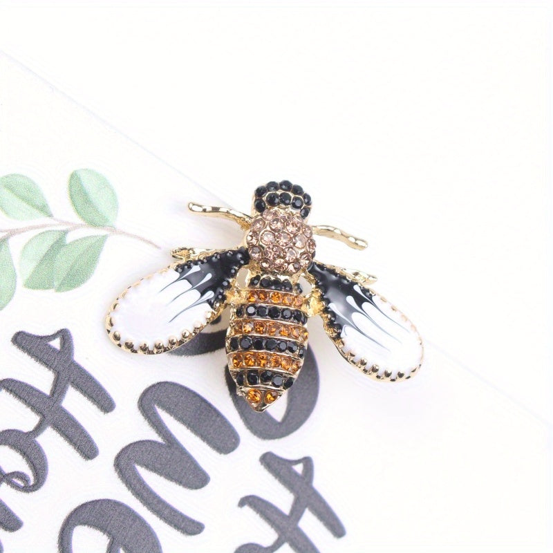 Charming and whimsical, this elegant and cute bee brooch pin features sparkling rhinestones. A delightful insect lapel accessory for women, it makes the perfect gift idea.