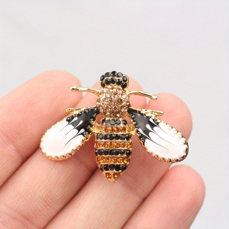 Charming and whimsical, this elegant and cute bee brooch pin features sparkling rhinestones. A delightful insect lapel accessory for women, it makes the perfect gift idea.