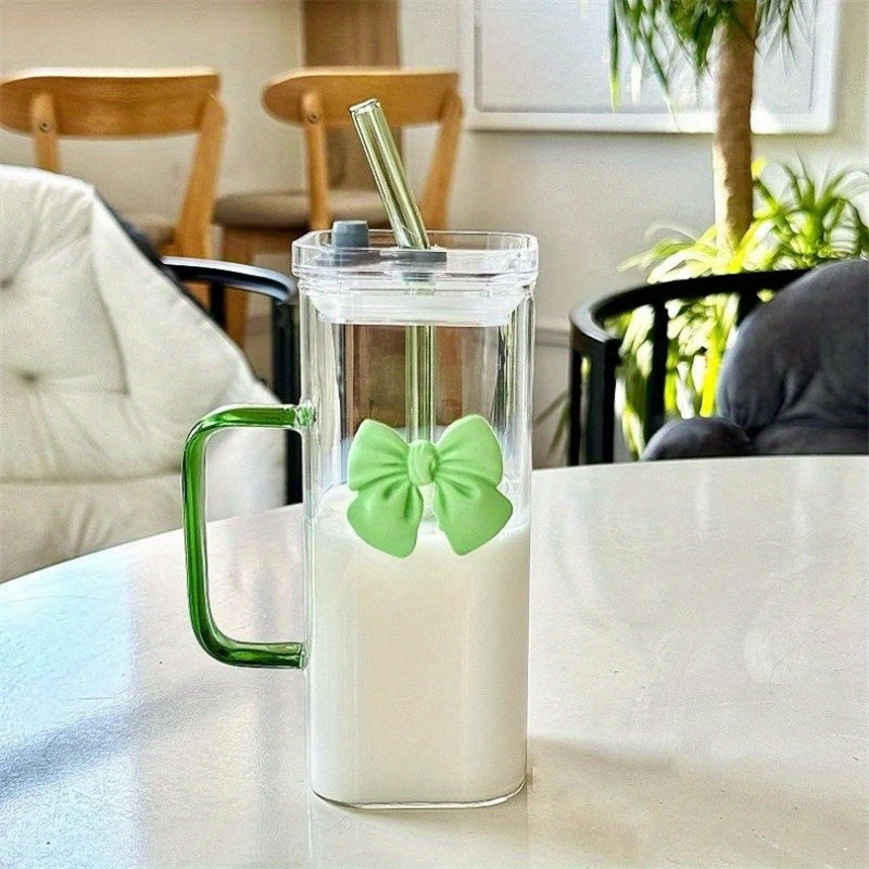 Clear Glass Mug with Handle features a bow decoration on a square drinking cup. This high-temperature resistant mug comes with a straw, perfect for enjoying coffee, milk, or water. Ideal for use at home, in the kitchen, or at parties.