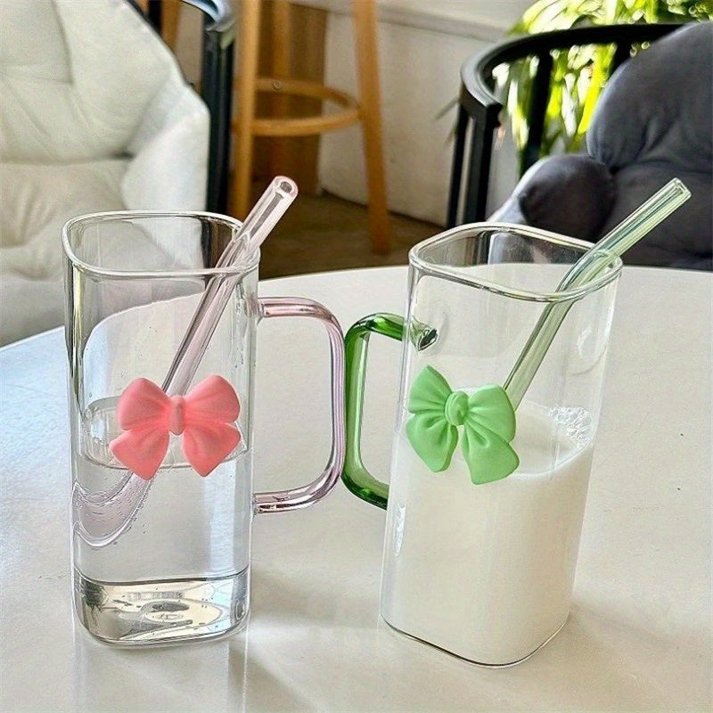 Clear Glass Mug with Handle features a bow decoration on a square drinking cup. This high-temperature resistant mug comes with a straw, perfect for enjoying coffee, milk, or water. Ideal for use at home, in the kitchen, or at parties.