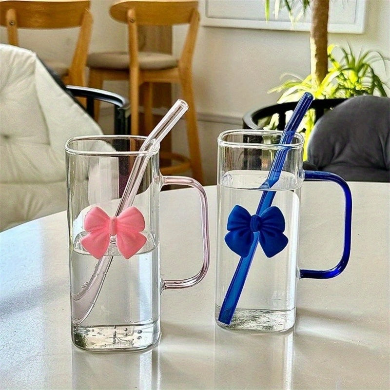 Clear Glass Mug with Handle features a bow decoration on a square drinking cup. This high-temperature resistant mug comes with a straw, perfect for enjoying coffee, milk, or water. Ideal for use at home, in the kitchen, or at parties.