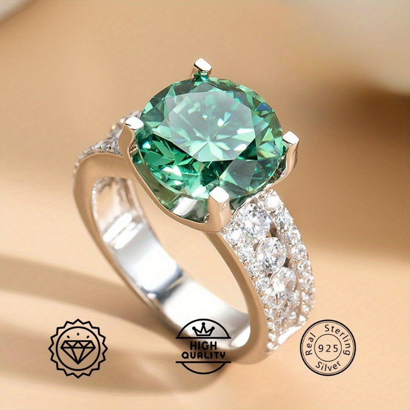 Moissanite Ring with 1 piece stone, 3/5/10 carats, set in 925 Sterling Silver with 18K Golden Plating. Features a 4-prong setting in a beautiful blue-green color. This elegant ring is perfect for vacations, proposals, music festivals, and sports.