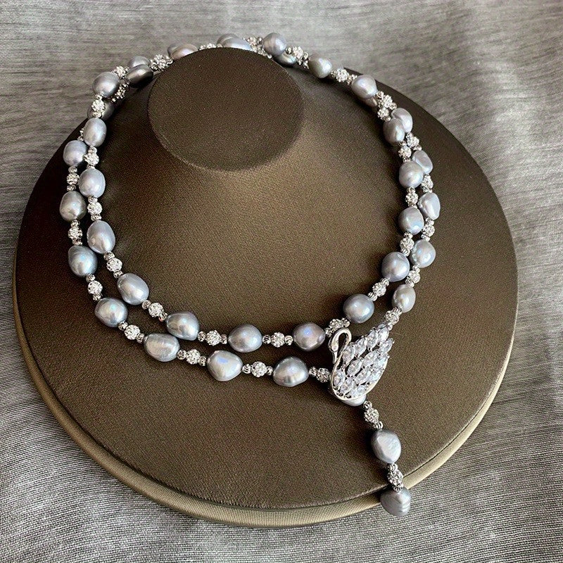 This sophisticated Baroque freshwater pearl Y-necklace features a swan clasp in a silvery gray hue, making it the ideal accessory for fall and winter fashion. It also makes for a perfect Thanksgiving gift.