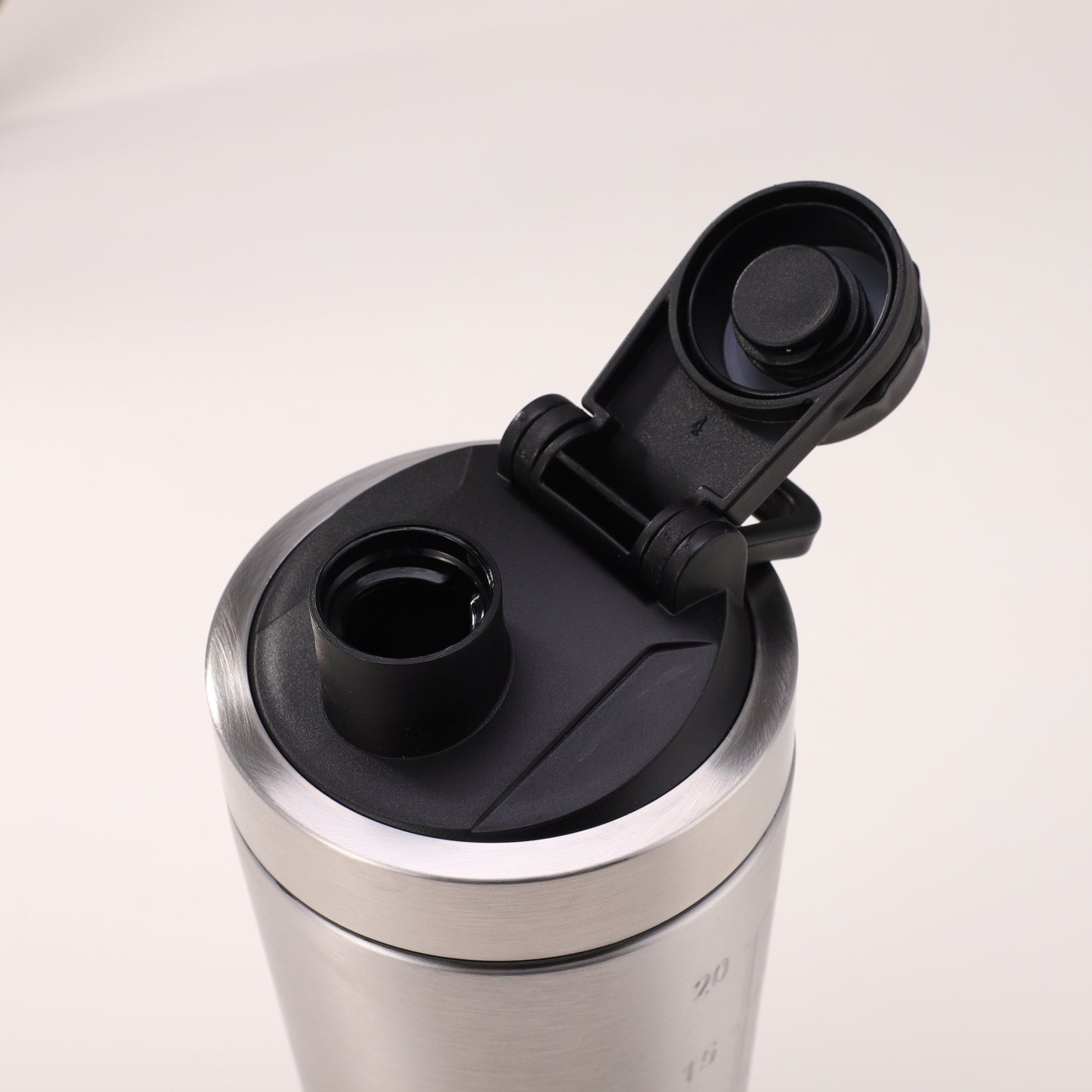 Protein powder shaker with single layer and bottom storage cup for holding protein powder, keychains, or a sports water bottle.