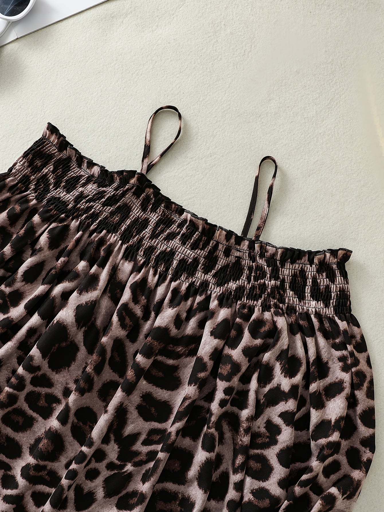 Stylish leopard print off-shoulder blouse with asymmetrical hem in non-stretch polyester blend for women.