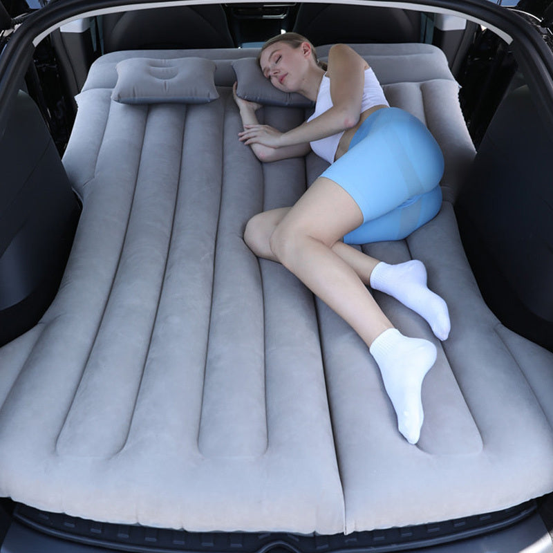 Portable car air mattress for road trips and camping, made of durable PVC material, fits in trunk as sleeping pad.