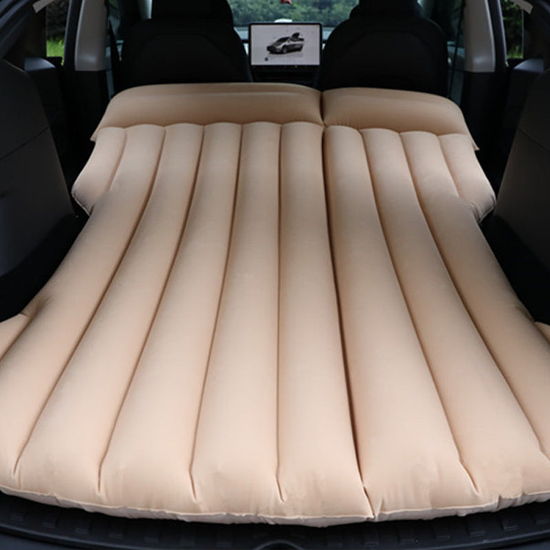 Portable car air mattress for road trips and camping, made of durable PVC material, fits in trunk as sleeping pad.